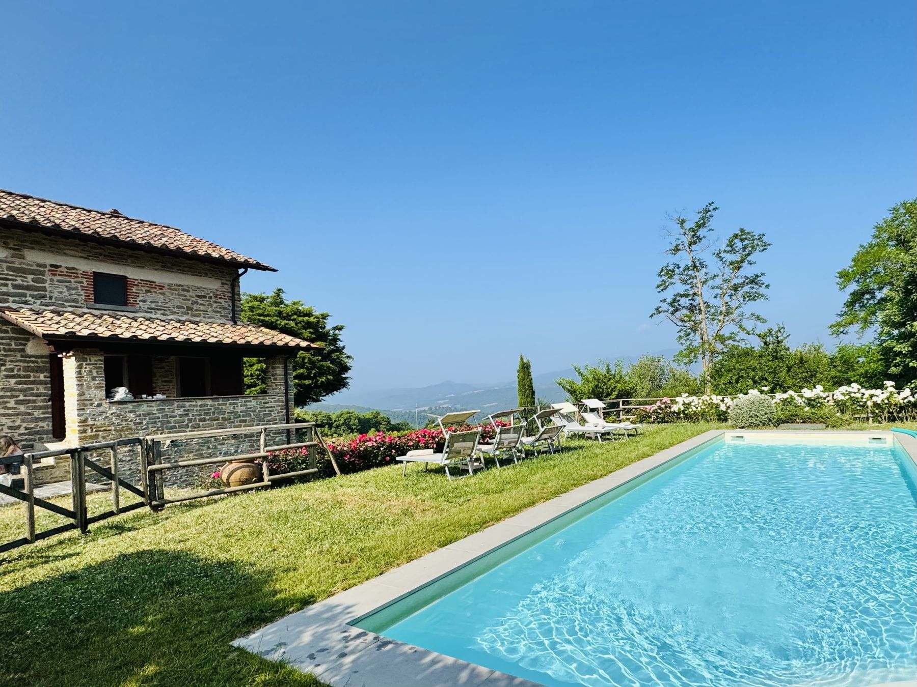 Steinhaus mit Pool und Rasen